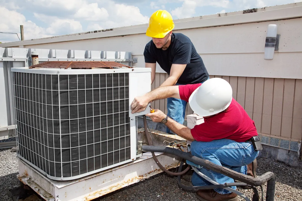 Technicians adjusting an AC motor for a Fairview Heights, IL customer