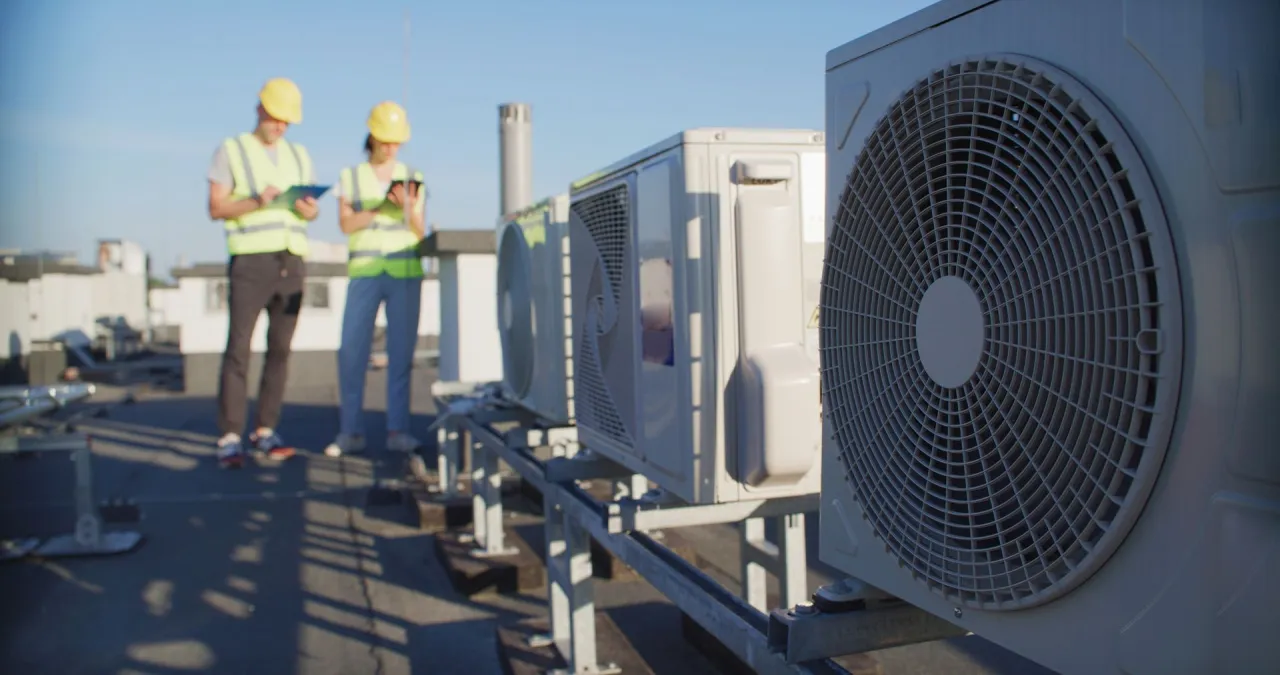 HVAC technicians installing an air conditioning motor for a Nashville, IL customer
